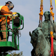 Workers remove a statue of Confederate General Robert E. Lee from Market Street Park July 10, 2021 in Charlottesville, Virginia. Initial plans to remove the statue four years ago sparked the infamous “Unite the Right” rally where 32 year old Heather Heyer was killed. (Photo by Win McNamee/Getty Images)